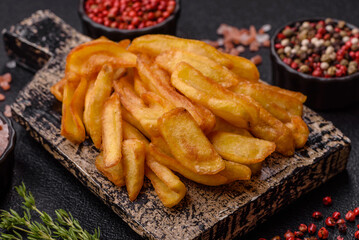 Fried crispy French fries with salt, spices, food for lunch