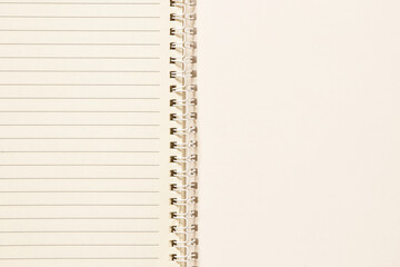 Open spiral notebook with blank lined sheets as a background for notes, planning