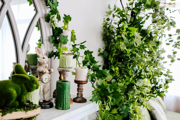 Decorative spring mantel with greenery and whimsical rabbit figurine in a cozy living room