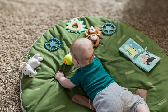 Baby doing tummy time with toys