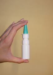 A nasal spray in a woman's hand close up