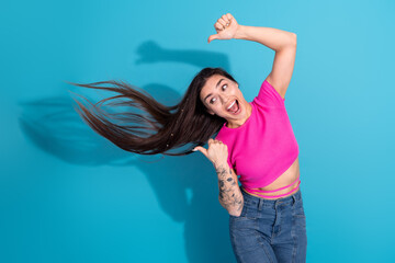 Excited Young Woman in Pink Crop Top and Jeans Expressing Happiness with Enthusiastic Gestures...