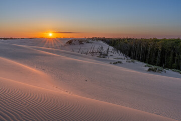 Serene Sunset Over Sandy Landscape