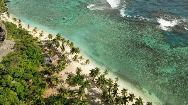 Drone orbit of Playa Front&oacute;n reveals dramatic rock formations, lush greenery, and a remote coastline untouched by development
