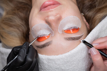 The process of professional lamination and dyeing of eyelashes and eyebrows in the salon....