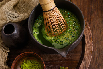 Traditional Matcha Preparation. Elegant matcha tea setup with whisk