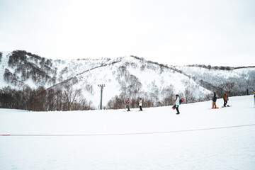 Skiers enjoy the slopes of Gala Yuzawa with stunning views of Ishiuchi Maruyama and Yuzawa Kogen in...
