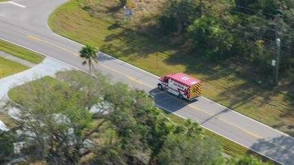 Emergency rescue truck from Florida fire services driving with sirens and lights on, responding to a critical incident.