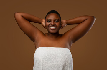 Love Yourself. Happy Chubby Black Woman Posing With Hands Raised Up, Showing Her Smooth Armpits,...