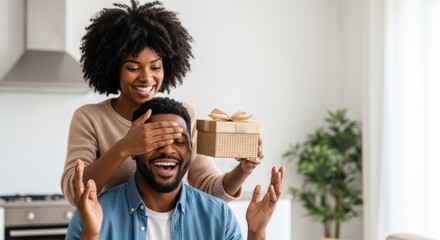 Happy couple share a moment, with a woman surprising her partner with a gift.