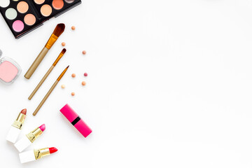 Flatlay of makeup cosmetics on white background. Blusher, mascara and lipstick, top view