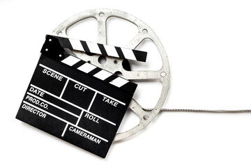 Naklejka premium Old movie film reel directors clapperboard on white background