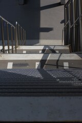 Striking shadows and strong lines define this urban staircase, showcasing modern design and stark contrasts in light and dark.