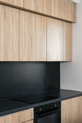 Modern kitchen interior with wooden cabinets and sleek black countertop design