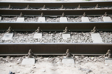 close-up of tram rails and concrete sleepers covered with crushed stone