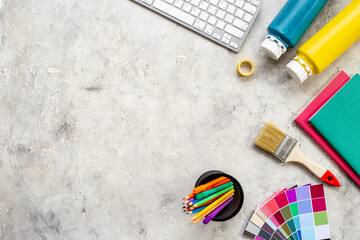 Creative designer workspace with color paint swatches and brushes