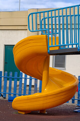Yellow Plastic Spiral Slide Fun Activity for Kids at Modern Playground