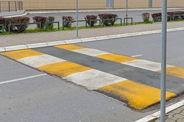 Yellow and White Speed Bump Made From Asphalt at City Street