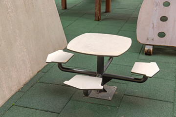 Floor Mounted Table With Chairs Set at Playground in City Park