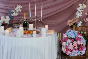 Romantic Table Setting with Champagne and Flowers for a Wedding Celebration, Pink Theme, Candles, Luxury Decor