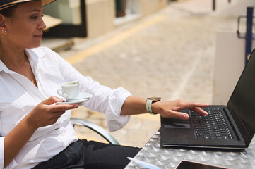 Professional Woman Working at an Outdoor Caf? With Coffee and Laptop