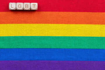 Lgbtq pride flag with wooden letter blocks displaying lgbt