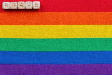 Brave message on rainbow pride flag background