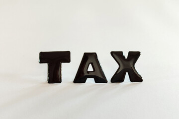 Tax reminder message. Black TAX letters on a white background. 