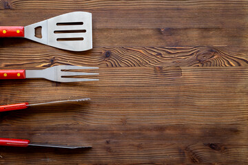 Set with barbecue utensils and equipment with red picnic napkin. Stainless steel tools. Top view