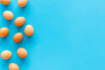 Set of chicken eggs on blue background, top view. Food pattern. Easter background