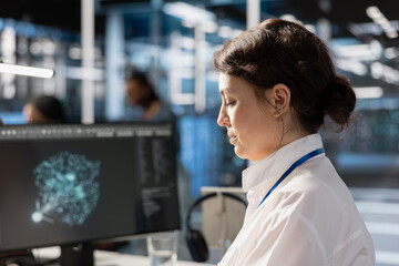 Data center computer scientist analyzing software logs metrics on PC monitor, optimizing systems....