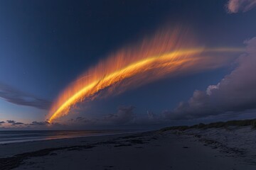 Fiery arc over the beach at dawn