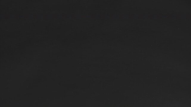 Hand-animated dust specks drift across black paper in subtle stop-motion. Seamless loop adds gritty vintage atmosphere behind titles, logos, credit rolls or noir scenes.