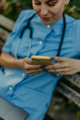 Medical worker using a smartphone during a break outdoors