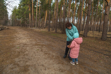 Grandmother and granddaughter walking in the forest