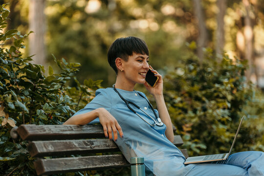 Medical professional enjoying a phone conversation outdoors