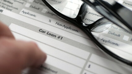 Finger tapping on car loan form
