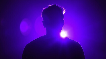 Silhouette of a person with a glowing purple light in an abstract background.
