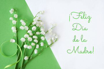 Lily of the valley flowers on green and white, text 