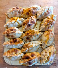 Empanada is a traditional Argentine dish. Several empanadas with different fillings in a delivery box