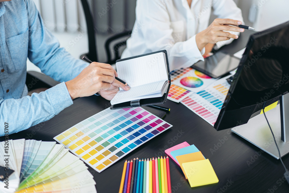 Aufkleber two creative graphic designer team working on color selection and drawing on graphic tablet, color s