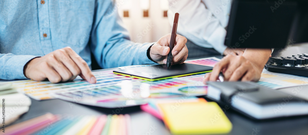 Poster two creative graphic designer team working on color selection and drawing on graphic tablet, color s