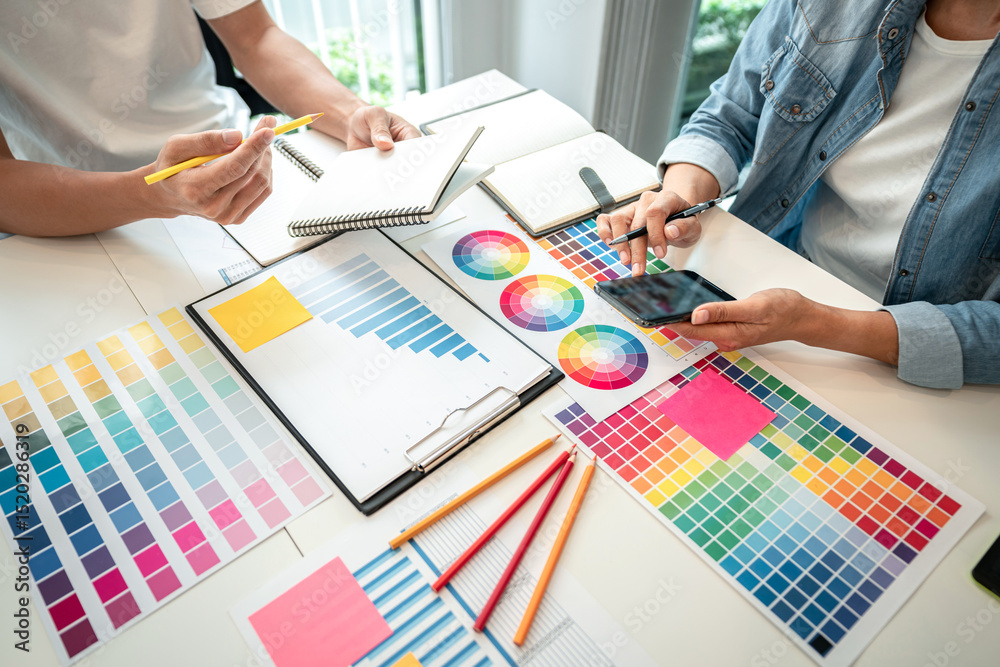 Poster two creative graphic designer team working on color selection and drawing on graphic tablet, color s