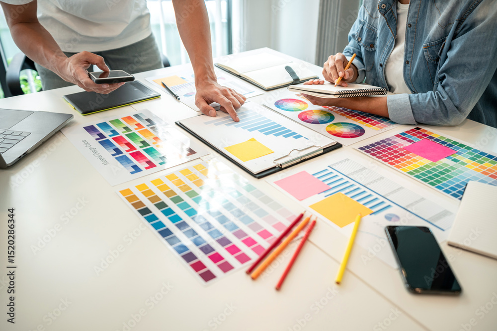 Poster two creative graphic designer team working on color selection and drawing on graphic tablet, color s