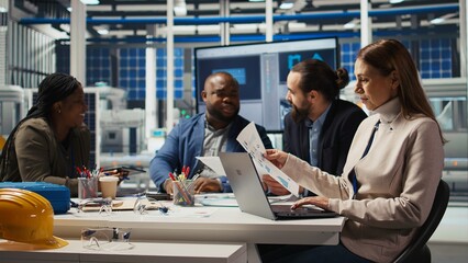 Factory research and development scientists use laptop to test materials for next generation solar...