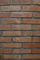Weathered red and brown brick wall with gray mortar lines, ideal for use in backgrounds, design textures, renovation themes, or building-related creative projects and digital assets.