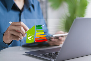 Energy efficiency Improvement concept, Eco-friendly homes for sustainable development. Businessman using laptop to energy efficiency rating assessment.