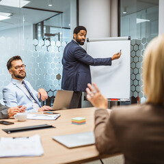 Focused businessman give a presentation to his colleagues in an office