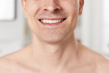 Smiling man after shaving at home, closeup