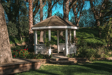 Close-Up of Gazebo with Palm Trees and Red Flowers in California Winery